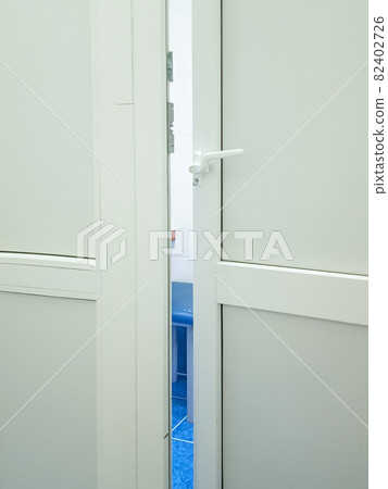 A slightly open door to a medical laboratory or a doctor's office, a vertical frame 82402726