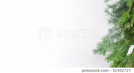 Christmas frame with Christmas tree branches on a white horizontal banner, a copy of the space 82402727