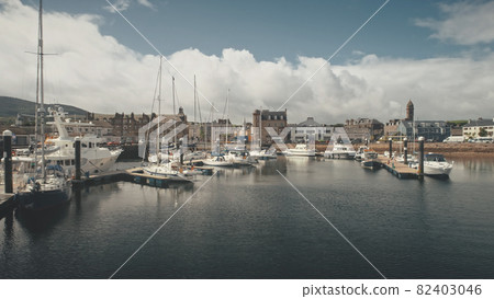 Ships, yachts at ocean bay aerial. Cityscape with old historic architecture landmark at port city Ships, yachts at ocean bay aerial. Cityscape with old historic architecture landmark at port city 82403046