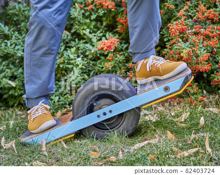one-wheeled electric skateboard in a backyard 82403724
