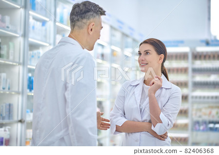 Man and woman talking at pharmacy 82406368