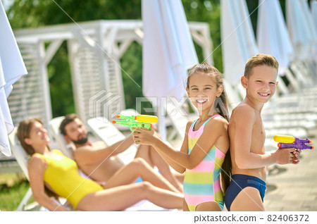 A family spending time on a beach 82406372