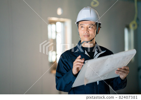 檢查圖畫的男性工作者 82407381