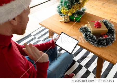Albino african american man wearing santa hat making video call on tablet with copy space 82408194