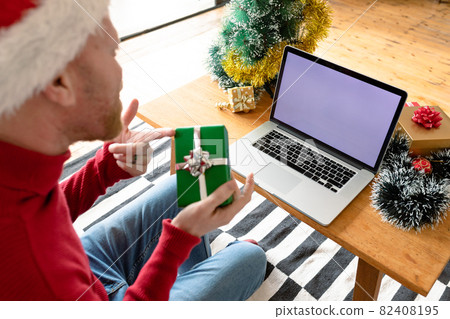 Albino african american man wearing santa hat making video call on laptop with copy space 82408195