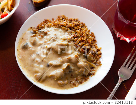 Popular dish of Russian cuisine is beef stroganoff with buckwheat porridge Popular dish of Russian cuisine is beef stroganoff with buckwheat porridge 82413118
