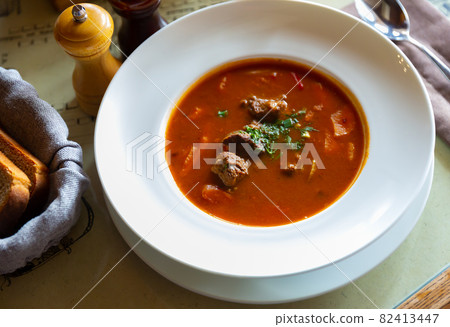 Popular dish of Russian cuisine is an appetizing hearty meat soup goulash Popular dish of Russian cuisine is an appetizing hearty meat soup goulash 82413447