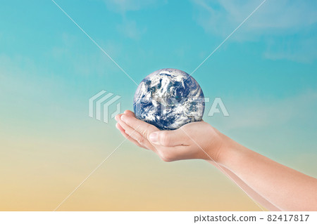 Environment day concept, Globe in child hands over blue sky background Environment day concept, Globe in child hands over blue sky background 82417817