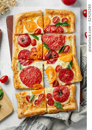 Delicious homemade square pizza with vegetables on white 82420260