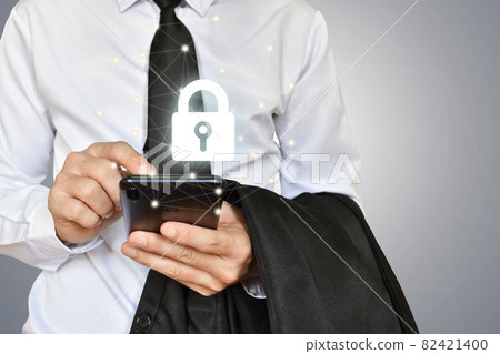 Businessman holding mobile phone with shield lock Businessman holding mobile phone with shield lock 82421400