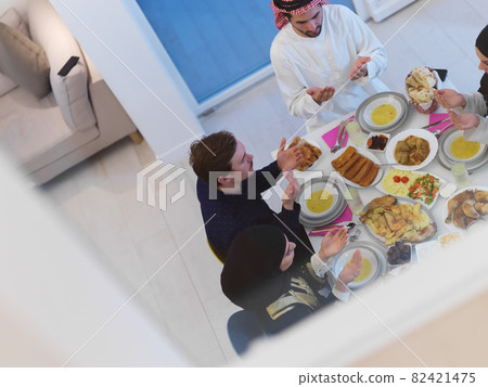 Top view of Muslim family making iftar dua to break fasting during Ramadan Top view of Muslim family making iftar dua to break fasting during Ramadan 82421475