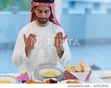 Muslim man making iftar dua to break fasting during Ramadan Muslim man making iftar dua to break fasting during Ramadan 82422658