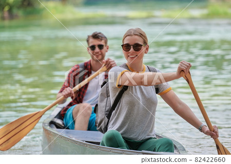 friends are canoeing in a wild river friends are canoeing in a wild river 82422660