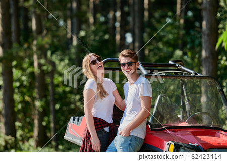 couple enjoying beautiful sunny day while driving a off road buggy couple enjoying beautiful sunny day while driving a off road buggy 82423414