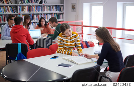 students group working on school project together on tablet computer at modern university students group working on school project together on tablet computer at modern university 82423428