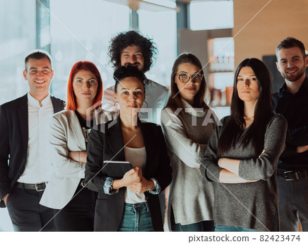 Young Smiling Managers Standing in Modern Office. Training in Office. Modern Office Concept. Woman in White Shirt. Man in Black Suit. Young Smiling Managers Standing in Modern Office. Training in Office. Modern Office Concept. Woman in White Shirt. Man in Black Suit. 82423474
