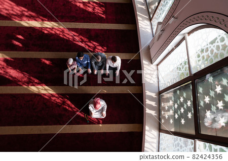 group of muslim people praying namaz in mosque. 82424356