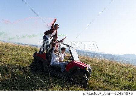 colorful torches while driving a off road buggy car 82424879