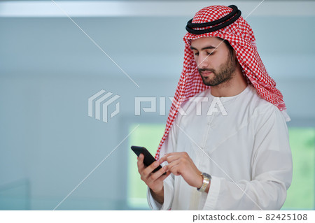 Portrait of young muslim businessman using mobile phone 82425108