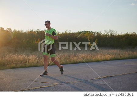 triathlon athlete running on morning trainig triathlon athlete running on morning trainig 82425361