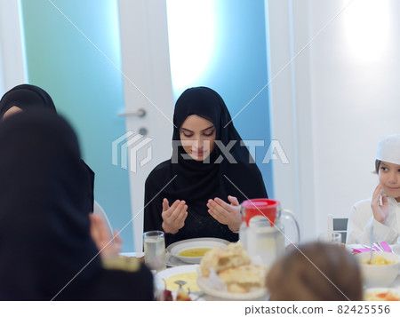 Muslim family making iftar dua to break fasting during Ramadan Muslim family making iftar dua to break fasting during Ramadan 82425556