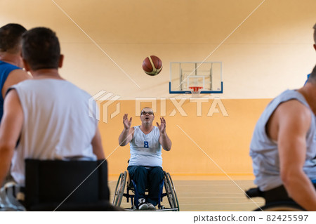 disabled war veterans in action while playing basketball on a basketball court with professional sports equipment for the disabled 82425597