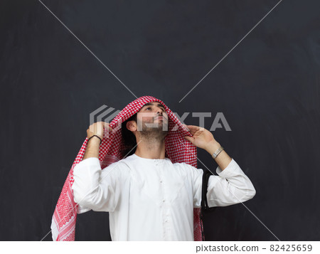 Portrait of young muslim man wearing traditional clothes Portrait of young muslim man wearing traditional clothes 82425659