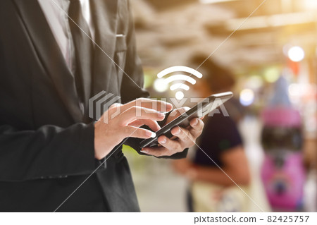 Man hand using mobile smartphone with wifi icon Man hand using mobile smartphone with wifi icon 82425757