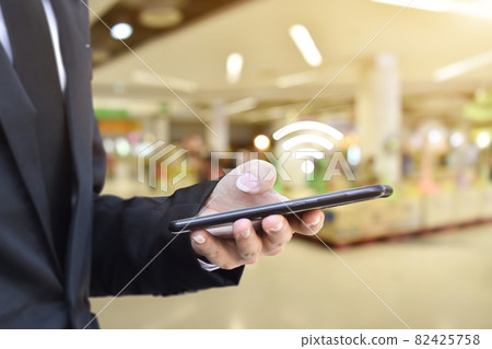Man hand using mobile smartphone with wifi icon Man hand using mobile smartphone with wifi icon 82425758
