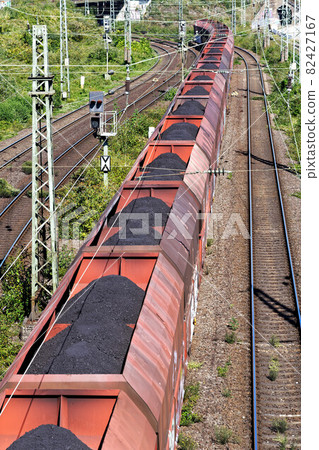 coal train passes under a bridge 82427167