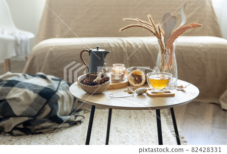 Details of home autumn decor and tea on the table in the room. 82428331