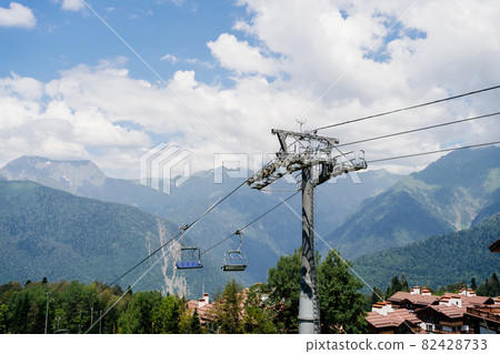 cable car with open trailers in the mountains.  82428733