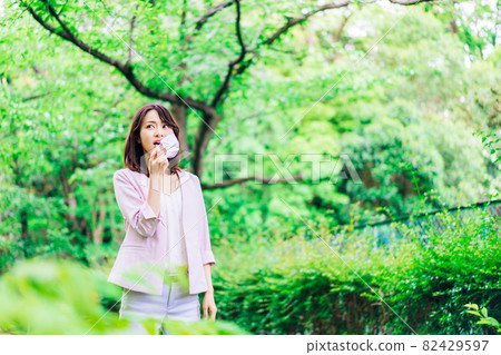 A young business woman who feels stuffy with a mask A young business woman who feels stuffy with a mask 82429597