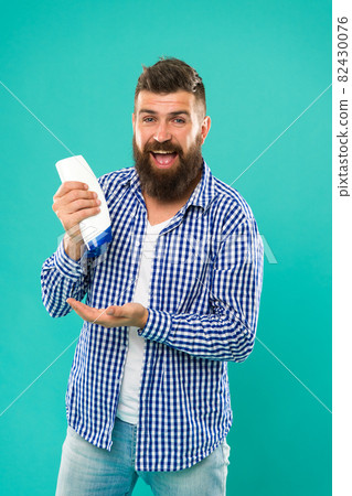 Man hold shampoo bottle. Hair care. Shampoo for daily  82430076