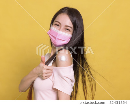 Young  woman covid-19 anti virus vaccine thumbs up 82431864