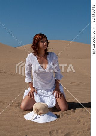woman in white dress in desert dunes  82436388