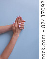 Trendy pink manicure. View from above of beautiful women's hands. Delicate skin. 82437092
