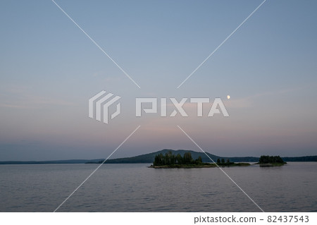 Beautiful view of lake, sky and island with trees or forest Beautiful view of lake, sky and island with trees or forest 82437543
