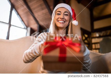 Happy Woman Giving Present To Laptop Webcam At Home Happy Woman Giving Present To Laptop Webcam At Home 82437568
