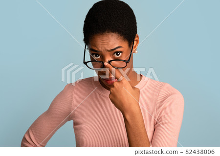 What Did You Say. Black Woman Adjusting Glasses And Looking At Camera What Did You Say. Black Woman Adjusting Glasses And Looking At Camera 82438006