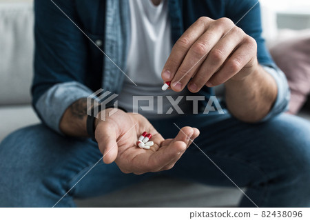 Colorful pharmaceutical medicine pills, narcotic drugs in capsules on palm Colorful pharmaceutical medicine pills, narcotic drugs in capsules on palm 82438096