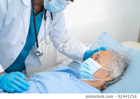Doctor help Asian senior or elderly old lady woman patient wearing a face mask in hospital for protect safety infection and kill Covid-19 Coronavirus. Doctor help Asian senior or elderly old lady woman patient wearing a face mask in hospital for protect safety infection and kill Covid-19 Coronavirus. 82441258