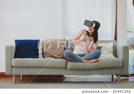 Asian woman in VR headset 82441268