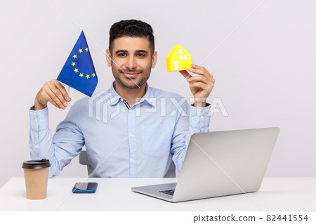 Emotional man sitting and working on office 82441554