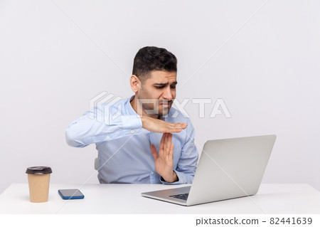 Emotional man sitting and working on office Emotional man sitting and working on office 82441639