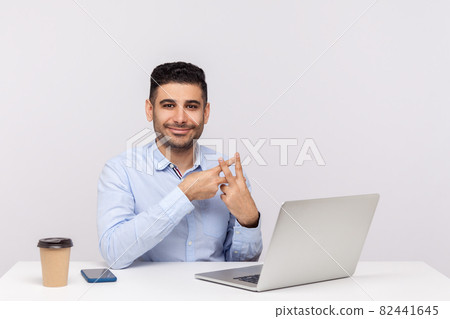 Emotional man sitting and working on office Emotional man sitting and working on office 82441645