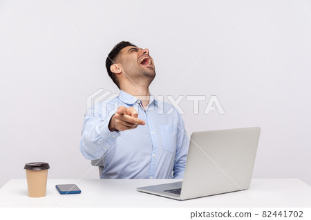 Emotional man sitting and working on office 82441702