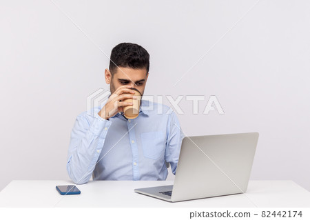 Emotional man sitting and working on office 82442174