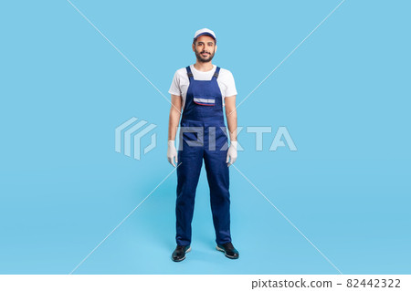 Portrait of worker man in uniform on blue background. Portrait of worker man in uniform on blue background. 82442322