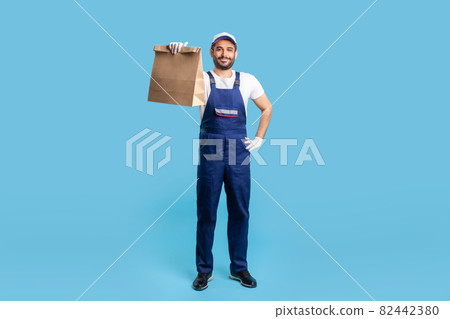 Portrait of worker man in uniform on blue background. 82442380
